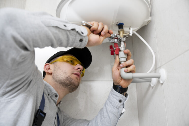 worker repairing water heater